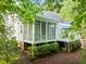 Exterior view of the home featuring a deck, screened in porch, and nice landscaping at 5405 Bluet Ct, Holly Springs, NC 27540
