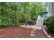 Wooded backyard featuring a hot tub and spacious deck for entertaining at 5405 Bluet Ct, Holly Springs, NC 27540