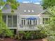 Exterior view of the home featuring a deck, screened in porch, and nice landscaping at 5405 Bluet Ct, Holly Springs, NC 27540
