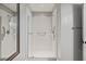 Modern walk-in shower with white subway tile, glass enclosure, and updated fixtures at 5405 Bluet Ct, Holly Springs, NC 27540