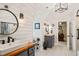 Bright bathroom with double sinks, Shiplap walls, and modern fixtures at 5405 Bluet Ct, Holly Springs, NC 27540