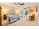 Cozy bedroom with two beds, ceiling fan, and a large window with view to the backyard at 5405 Bluet Ct, Holly Springs, NC 27540
