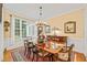 Bright dining area with hardwood floors, wainscoting, and adjacent furniture at 5405 Bluet Ct, Holly Springs, NC 27540
