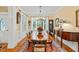 Bright dining room featuring hardwood floors, wainscoting, and large window at 5405 Bluet Ct, Holly Springs, NC 27540