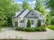 Charming home with a manicured lawn, three-car garage, and elegant stone and siding at 5405 Bluet Ct, Holly Springs, NC 27540