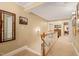 Bright hallway with natural light, crown molding, and wood railing overlooking the staircase at 5405 Bluet Ct, Holly Springs, NC 27540