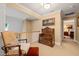 Sitting area featuring a wooden chair, upholstered stool and ornate chest with bedroom view at 5405 Bluet Ct, Holly Springs, NC 27540