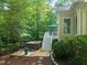 Relax in the hot tub next to the deck, surrounded by a lush, wooded landscape at 5405 Bluet Ct, Holly Springs, NC 27540