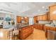 Gourmet kitchen features an island with seating, stainless steel appliances, and custom wood cabinetry at 5405 Bluet Ct, Holly Springs, NC 27540