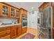 Kitchen featuring wood cabinets, stainless steel appliances, and hardwood floors, offering functionality and style at 5405 Bluet Ct, Holly Springs, NC 27540