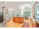 Bright, open kitchen with an island, pendant lighting, hardwood floors, and a view of the dining area at 5405 Bluet Ct, Holly Springs, NC 27540