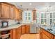 Traditional kitchen with wood cabinets, granite countertops, stainless steel appliances, and hardwood floors at 5405 Bluet Ct, Holly Springs, NC 27540