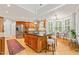 Spacious kitchen boasts wood cabinets, granite countertops, stainless steel appliances, and bright natural light at 5405 Bluet Ct, Holly Springs, NC 27540