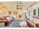 Bright living area with fireplace, tall ceilings, and natural light, with view of dining room at 5405 Bluet Ct, Holly Springs, NC 27540