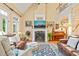 Open living area with fireplace, tall ceilings, and natural light, and access to staircase at 5405 Bluet Ct, Holly Springs, NC 27540