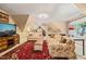 Inviting living room area with patterned sofas, and large red area rug in front of TV at 5405 Bluet Ct, Holly Springs, NC 27540