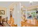 Spacious living area featuring hardwood floors, elegant columns, and an open staircase at 5405 Bluet Ct, Holly Springs, NC 27540