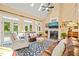 Inviting living room features high ceilings, a cozy fireplace, and ample natural light from multiple windows at 5405 Bluet Ct, Holly Springs, NC 27540