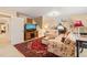 Cozy living room with sloped ceilings, carpet, and traditional furnishings at 5405 Bluet Ct, Holly Springs, NC 27540