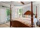 Stunning main bedroom with a four-poster bed and access to a private screened-in porch at 5405 Bluet Ct, Holly Springs, NC 27540