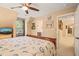 Well-lit main bedroom with a ceiling fan, large window, and access to an ensuite bathroom at 5405 Bluet Ct, Holly Springs, NC 27540
