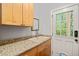 Mud room with a granite countertop, sink, cabinets, a mirror and a view to the outdoors at 5405 Bluet Ct, Holly Springs, NC 27540