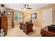 Comfortable home office boasts a classic desk, ceiling fan, and bright window at 5405 Bluet Ct, Holly Springs, NC 27540