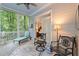 Relaxing screened-in porch with comfortable seating, charming decor, and views of nature at 5405 Bluet Ct, Holly Springs, NC 27540