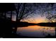 Scenic sunset reflecting off the still lake water at 5405 Bluet Ct, Holly Springs, NC 27540