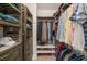 Well-organized walk-in closet featuring custom shelving, hanging rods, and storage for shoes and clothing at 5405 Bluet Ct, Holly Springs, NC 27540