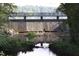 Scenic view of the water dam with lush greenery and rocks lining the water at 5405 Bluet Ct, Holly Springs, NC 27540