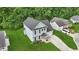 Aerial view of a home with a well-kept lawn, a driveway, and mature trees at 5408 Gunnette Dr, Raleigh, NC 27610