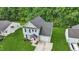 Aerial view of a home with a dark roof, manicured lawn, and a driveway at 5408 Gunnette Dr, Raleigh, NC 27610