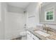 Bathroom featuring granite vanity, mirror, and shower-tub combo at 5408 Gunnette Dr, Raleigh, NC 27610
