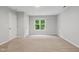 Inviting bedroom with natural light, neutral walls, and cozy carpeting at 5408 Gunnette Dr, Raleigh, NC 27610