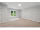 Bright bedroom featuring a large window, neutral walls, and carpet flooring at 5408 Gunnette Dr, Raleigh, NC 27610