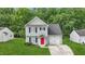 Charming two-story home with a well-manicured lawn, a driveway, and a bright red front door at 5408 Gunnette Dr, Raleigh, NC 27610