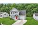 Inviting two-story home with a driveway, attached garage and lush green lawn at 5408 Gunnette Dr, Raleigh, NC 27610