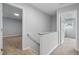 Upstairs hallway with carpeted stairs and access to additional rooms at 5408 Gunnette Dr, Raleigh, NC 27610