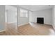 Spacious living room with fireplace, hardwood floors, and neutral walls at 5408 Gunnette Dr, Raleigh, NC 27610