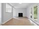 Bright living room with fireplace, french doors, and wood flooring at 5408 Gunnette Dr, Raleigh, NC 27610