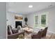 Cozy living room with fireplace, comfortable seating, and plenty of natural light at 5408 Gunnette Dr, Raleigh, NC 27610