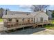 A spacious wooden deck wraps around this charming home, perfect for outdoor relaxation and entertaining at 5437 Grasshopper Rd, Raleigh, NC 27610