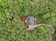 Aerial view of a home with an expansive driveway surrounded by lush, mature trees at 5805 Laurel Rock Ln, Raleigh, NC 27613