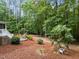 Relaxing backyard with an outdoor seating area nestled within mature landscaping and greenery at 5805 Laurel Rock Ln, Raleigh, NC 27613