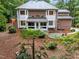 An inviting backyard features mature landscaping, a patio and an outdoor dining space at 5805 Laurel Rock Ln, Raleigh, NC 27613