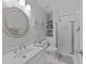 Bright bathroom with white vanity, framed mirror, tile shower, and decorative accents at 5805 Laurel Rock Ln, Raleigh, NC 27613