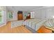 Bedroom with hardwood floors, a dresser, a TV, windows, and a neutral color scheme at 5805 Laurel Rock Ln, Raleigh, NC 27613