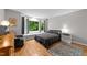 Bedroom featuring hardwood floors, a cozy window seat, and a large window with scenic views at 5805 Laurel Rock Ln, Raleigh, NC 27613