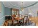 Stunning dining room featuring a beautiful rug, elegant chandelier, and large hutch for storage at 5805 Laurel Rock Ln, Raleigh, NC 27613